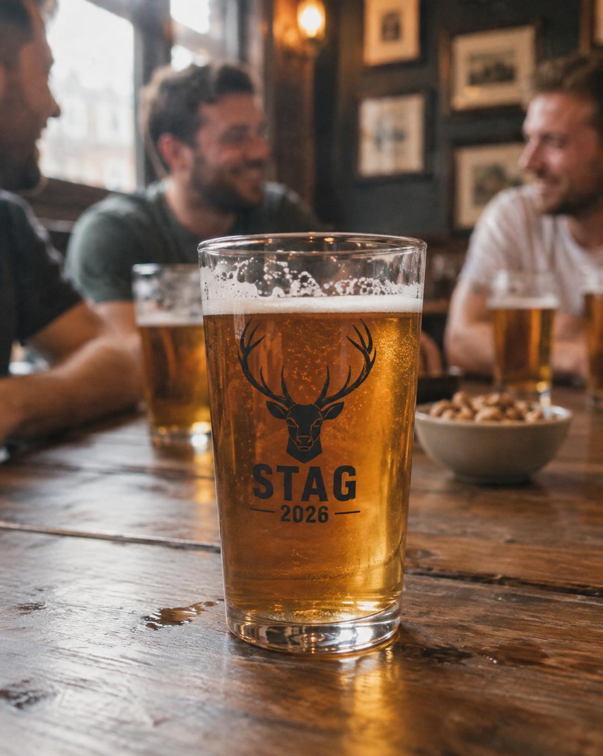 Pint glass with a black Stag 2026 deer badge on a pub table